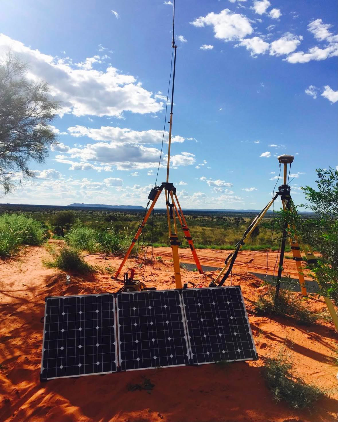Survey equipment and solar panel set up on a remote red-earth site