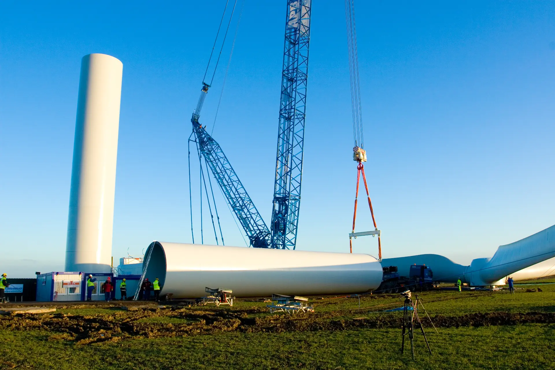 Crane lifting a wind turbine nacelle on a construction site